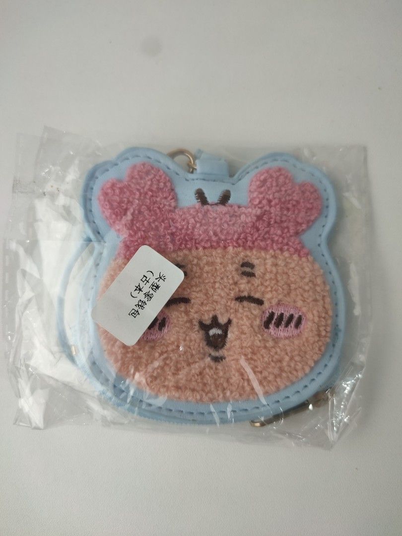chiikawa face sagara mini pouch (Category: Wallets & Card holders) located in Manila. Submitted by epicmountain-f20453 (Listing ID 1462359963, Image 1). Description: - Adorable light blue coin purse with a cute bear face design. - Features soft pink fuzzy ears and face details. - Secure zipper closure to keep your items safe. - Includes a convenient keychain attachment. - Ideal for storing coins, keys, earbuds, and other small essentials. - A per