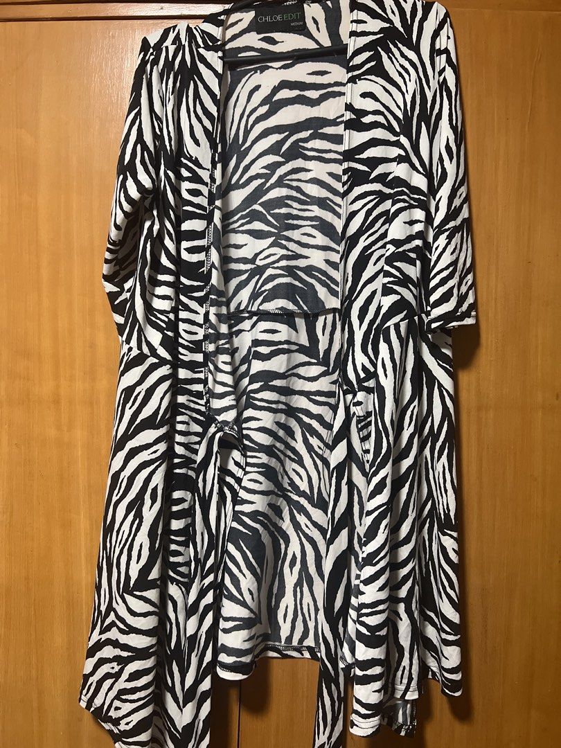 Chloe Edit Zebra Print Wrap Dress Medium (Category: Dresses) located in Pasig City. Submitted by zebteashoppe01 (Listing ID 1462399197, Image 1). Description: - Brand: Chloe Edit - Print: Zebra - Style: Wrap Dress - Sleeves: 3/4 length - Waist: Ties for adjustable fit - Skirt: Flattering A-line - Size: Medium - Occasion: Versatile for casual or night Wrap around dress 09096535540 gcash mop Pasig Jnt .