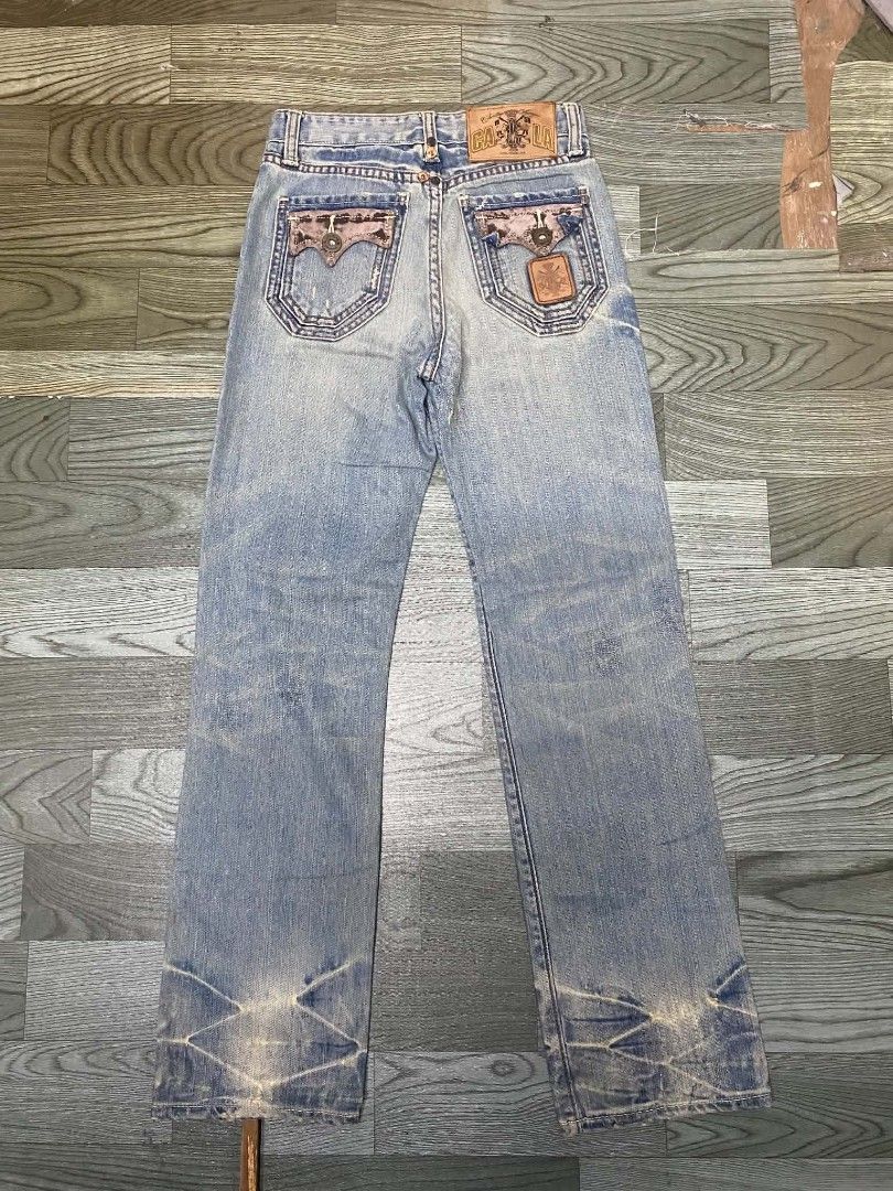 Christian Audigier Jeans (Category: Jeans) located in Pasig City. Submitted by jstnisidor81288 (Listing ID 1462420617, Image 2). Description: - Light wash denim jeans - Distressed details for a stylish look - Unique pocket designs - Branding on the back - Straight leg fit - Some fading and wear consistent with the style - A great statement piece size 27 length 38.