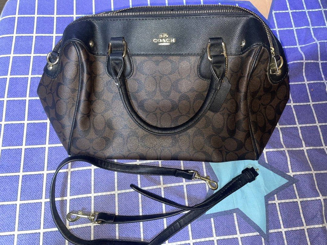Coach Bag (Category: Luxury Bags & Wallets) located in Bulacan. Submitted by keytxcx (Listing ID 1462352319, Image 2). Description: Classic Coach monogram satchel - Slightly used! - Color: Brown and Black - Features top handles - Detachable shoulder strap included - Interior: 1 zip pocket, slip pockets - Gold hardware details - Ideal everyday bag - Used but not abused - Bought at Ukay ukay! - No box & dustbag! - See the condition in the pics - Pr