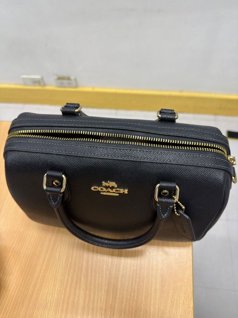 Coach Black Leather Satchel Bag (Category: Luxury Bags & Wallets) located in Valenzuela. Submitted by nikay07 (Listing ID 1462346582, Image 3). Description: - Classic black Coach satchel bag - Pebbled leather exterior - Gold hardware accents - Features top handles - Includes detachable Coach tag - Ideal for everyday use - Clean interior, well-maintained - Ready for its new owner.