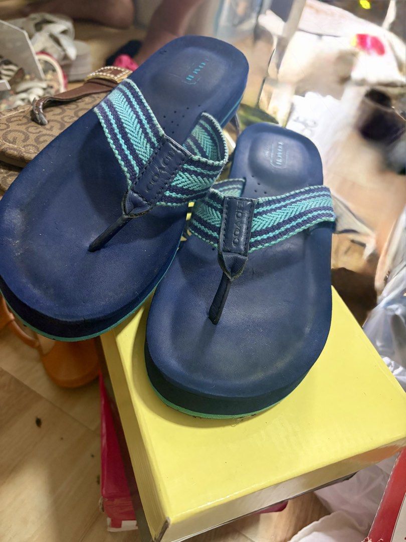 Coach Blue Flip-flops with Teal Stripes (Category: Slippers and slides) located in Caloocan City. Submitted by juana_finds26 (Listing ID 1462409113, Image 1). Description: - Brand: Coach - Color: Blue - Strap Details: Teal and light blue stripes - Sole: Blue with light green accent - Condition: Good for casual wear, with some signs of wear on soles and straps..
