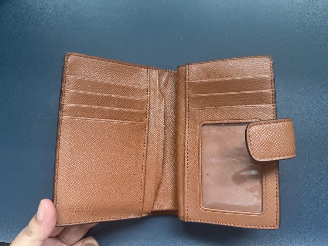 Coach Brown Leather Bifold Wallet (Category: Luxury Bags & Wallets) located in Taguig. Submitted by seller198 (Listing ID 1462301046, Image 2). Description: - Genuine Coach brown leather bifold wallet - Multiple card slots for organization - Clear ID window for easy access - Secure snap closure to keep essentials safe - Iconic Coach logo embossed on the front - Bought 4 years ago no longer have the receipt and box. .