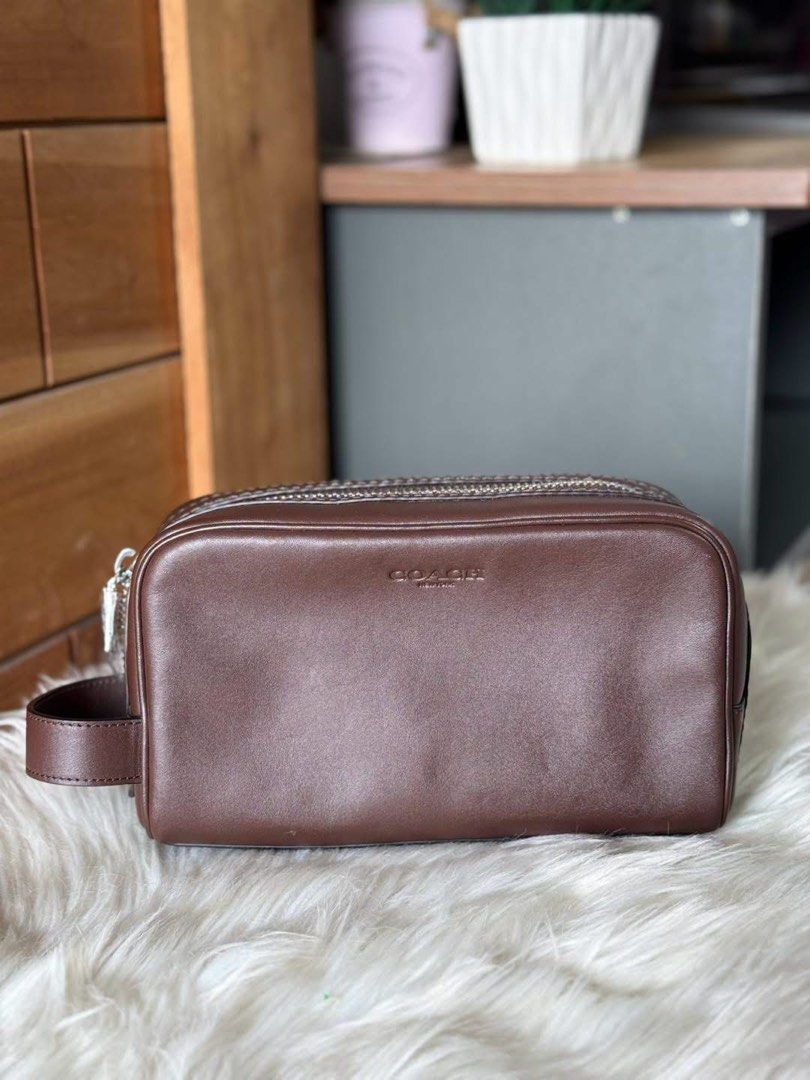 Coach Brown Leather Pouch/Clutch (Category: Purses & Pouches) located in Manila. Submitted by clairetot (Listing ID 1462370344, Image 1). Description: Original clutch Brown leather pouch from Coach. Has a zip closure and a side handle. Great for organizing essentials or as a small clutch. Clean interior. Minimal signs of wear..
