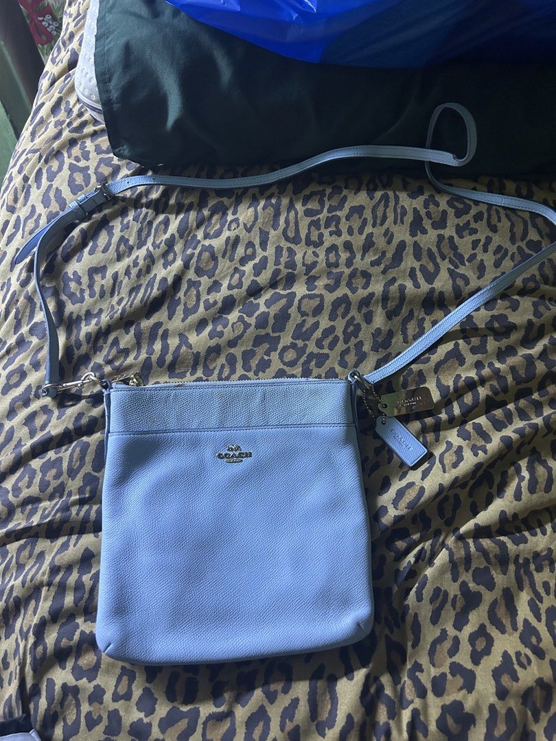Coach Light Blue Leather Crossbody Bag (Category: Cross-body Bags) located in Quezon City. Submitted by thriftxgoods (Listing ID 1462387056, Image 1). Description: - Authentic Coach crossbody bag - Color: Light blue - Material: Genuine Leather - Closure: Zipper - Strap: Adjustable - Compartments: 1 main compartment, 1 inner pocket - Condition: Minor marks on front and inside - Ideal for: Everyday use.