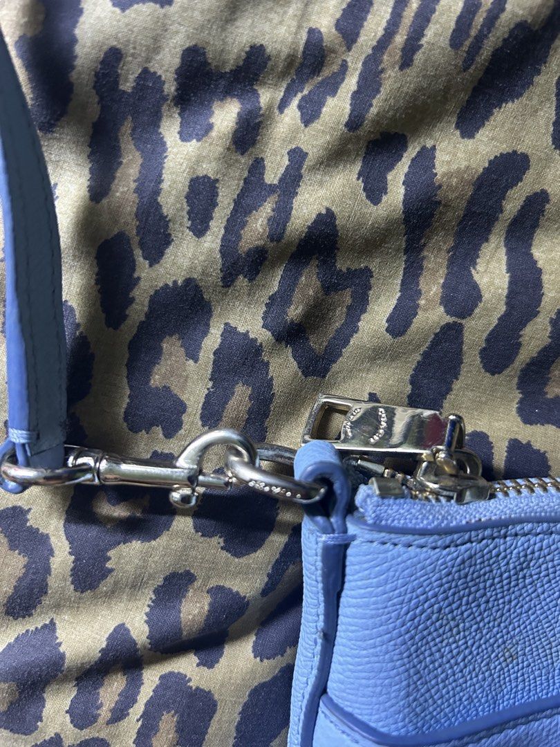 Coach Light Blue Leather Crossbody Bag (Category: Cross-body Bags) located in Quezon City. Submitted by thriftxgoods (Listing ID 1462387056, Image 2). Description: - Authentic Coach crossbody bag - Color: Light blue - Material: Genuine Leather - Closure: Zipper - Strap: Adjustable - Compartments: 1 main compartment, 1 inner pocket - Condition: Minor marks on front and inside - Ideal for: Everyday use.