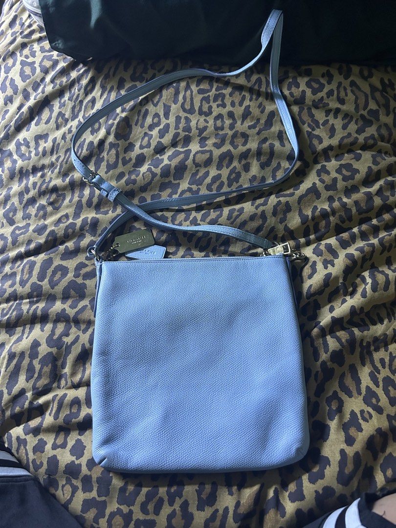 Coach Light Blue Leather Crossbody Bag (Category: Cross-body Bags) located in Quezon City. Submitted by thriftxgoods (Listing ID 1462387056, Image 3). Description: - Authentic Coach crossbody bag - Color: Light blue - Material: Genuine Leather - Closure: Zipper - Strap: Adjustable - Compartments: 1 main compartment, 1 inner pocket - Condition: Minor marks on front and inside - Ideal for: Everyday use.