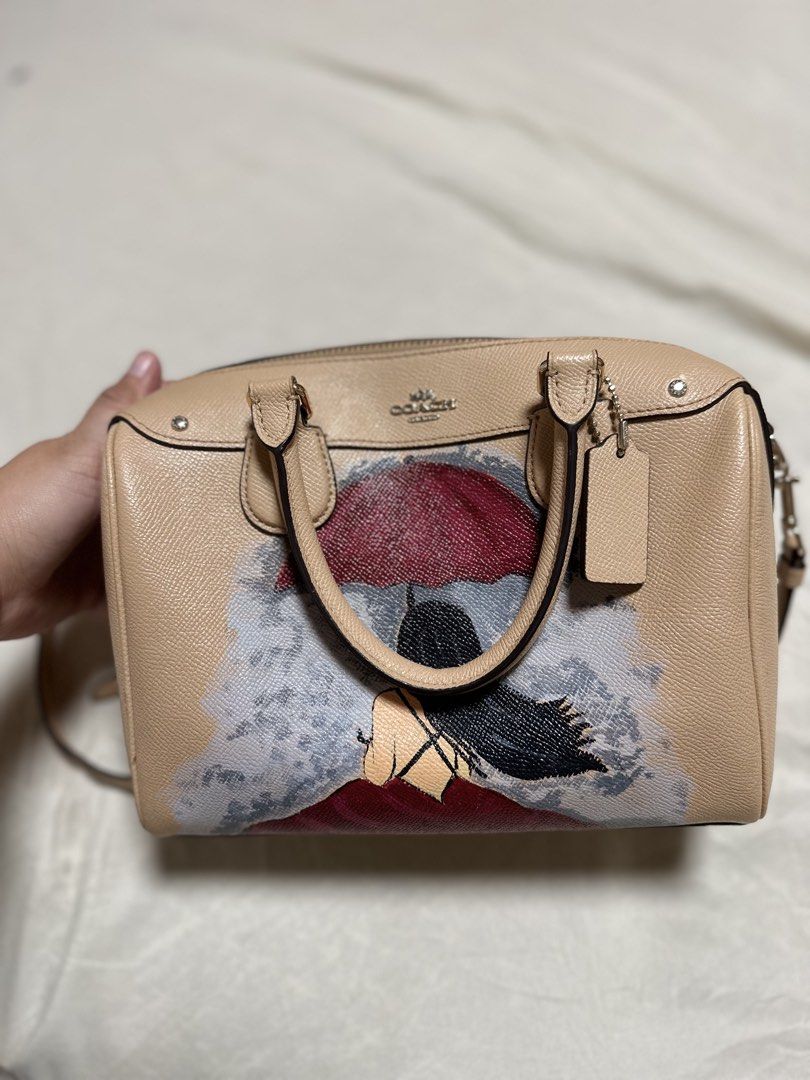 Coach Monogram Canvas Satchel Bag with Art Print (Category: Luxury Bags & Wallets) located in Cotabato. Submitted by pawpaw1027 (Listing ID 1462361949, Image 1). Description: - Tan Coach satchel bag - Unique art print on the front - Coach logo detail on top - Top handles for carrying - Detachable strap for versatile wear - Makes a great statement piece.