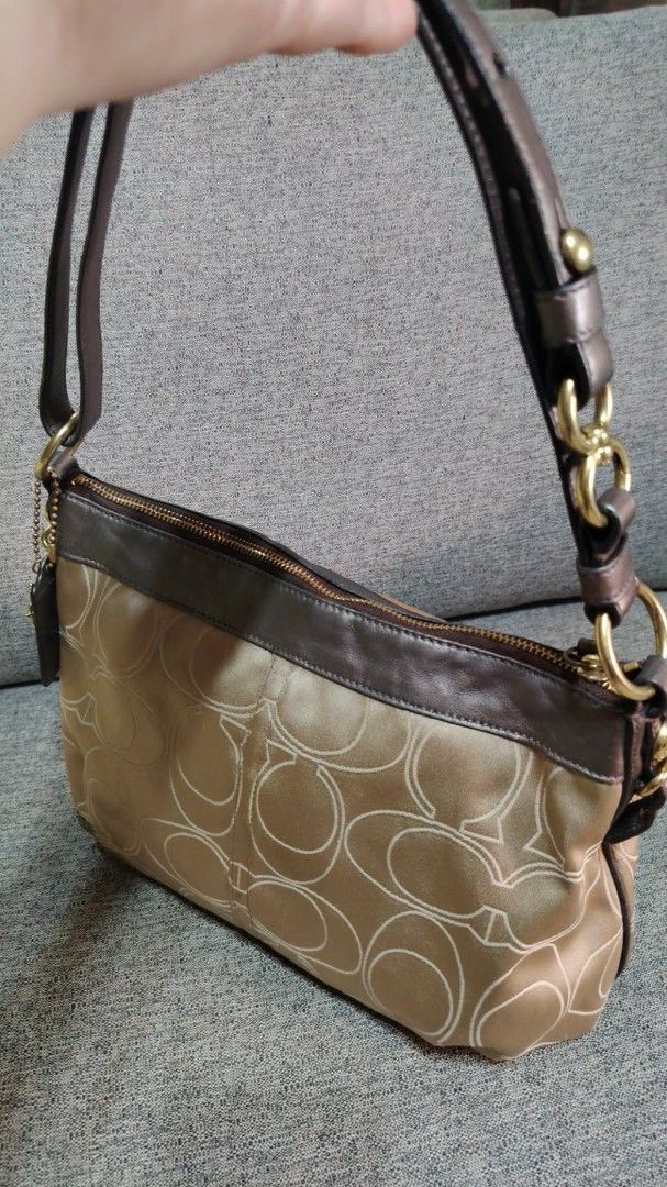 Coach Monogram Shoulder Bag (Category: Luxury Bags & Wallets) located in Caloocan City. Submitted by tweetyferrer (Listing ID 1462394867, Image 1). Description: Classic Coach shoulder bag in tan with signature 'C' monogram. Features brown leather trim, gold hardware, and a secure zipper closure. Includes a Coach charm. Perfect for daily use..