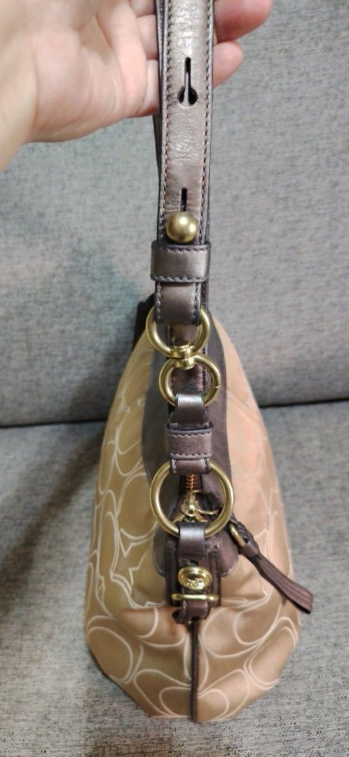 Coach Monogram Shoulder Bag (Category: Luxury Bags & Wallets) located in Caloocan City. Submitted by tweetyferrer (Listing ID 1462394867, Image 2). Description: Classic Coach shoulder bag in tan with signature 'C' monogram. Features brown leather trim, gold hardware, and a secure zipper closure. Includes a Coach charm. Perfect for daily use..