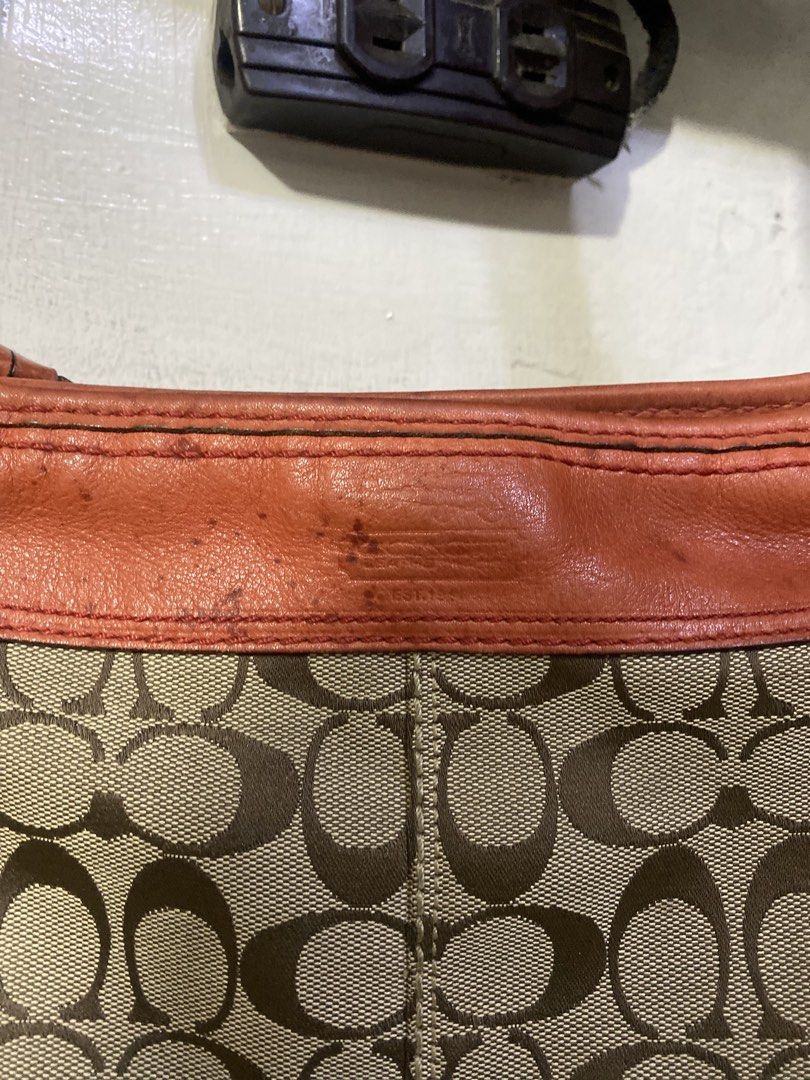 Coach Monogram Shoulder Bag with Orange Leather Trim (Category: Luxury Bags & Wallets) located in Manila. Submitted by anthony1723 (Listing ID 1462323777, Image 3). Description: - Authentic Coach monogram shoulder bag - Stylish orange leather trim and strap - Interior zip and slip pockets for organization - Serial number clearly visible on inner leather tag - Shows some signs of wear on the leather trim, adding character - Ideal and practical bag