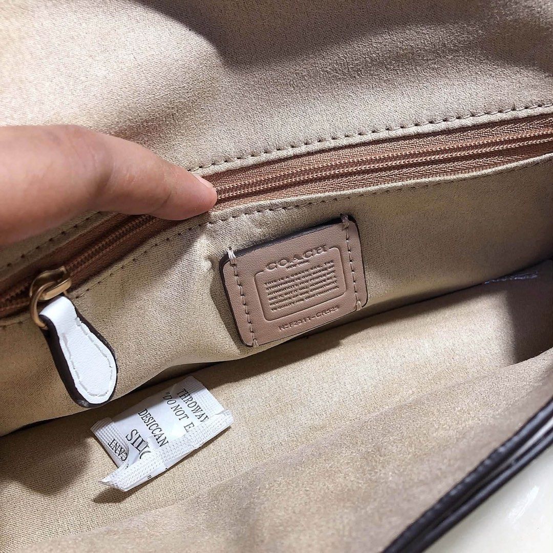 Coach New York White Leather Shoulder Bag (Category: Community) located in Angeles City. Submitted by migs_font29 (Listing ID 1462373232, Image 2). Description: - Authentic Coach New York white leather shoulder bag - Elegant gold hardware clasp closure - Interior zip pocket and slip pocket for organization - Comes with original Coach dust bag - Versatile for everyday wear or special events.
