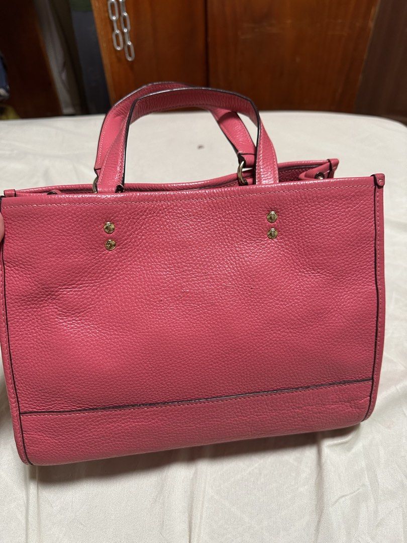 Coach Pink Leather Tote Bag (Category: Luxury Bags & Wallets) located in Cotabato. Submitted by pawpaw1027 (Listing ID 1462362907, Image 3). Description: - Authentic Coach pink pebbled leather tote bag - Features iconic circular Coach New York logo on the front - Comfortable top handles for easy carrying - Includes a stylish detachable hangtag - Elegant gold hardware details - Generously sized interior for all your essentials - Ideal for everyday