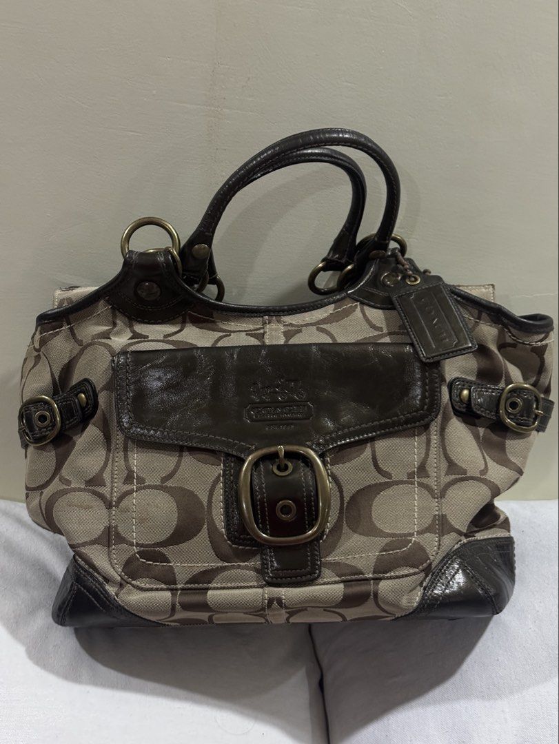 Coach Signature Canvas Monogram Handbag (Category: Luxury Bags & Wallets) located in Paranaque City. Submitted by ivvyyxx (Listing ID 1462348100, Image 1). Description: - Classic Coach monogram shoulder bag - Features brown leather trim and buckle details - Spacious interior for essentials - Timeless and stylish design - Great for everyday use or special occasions.
