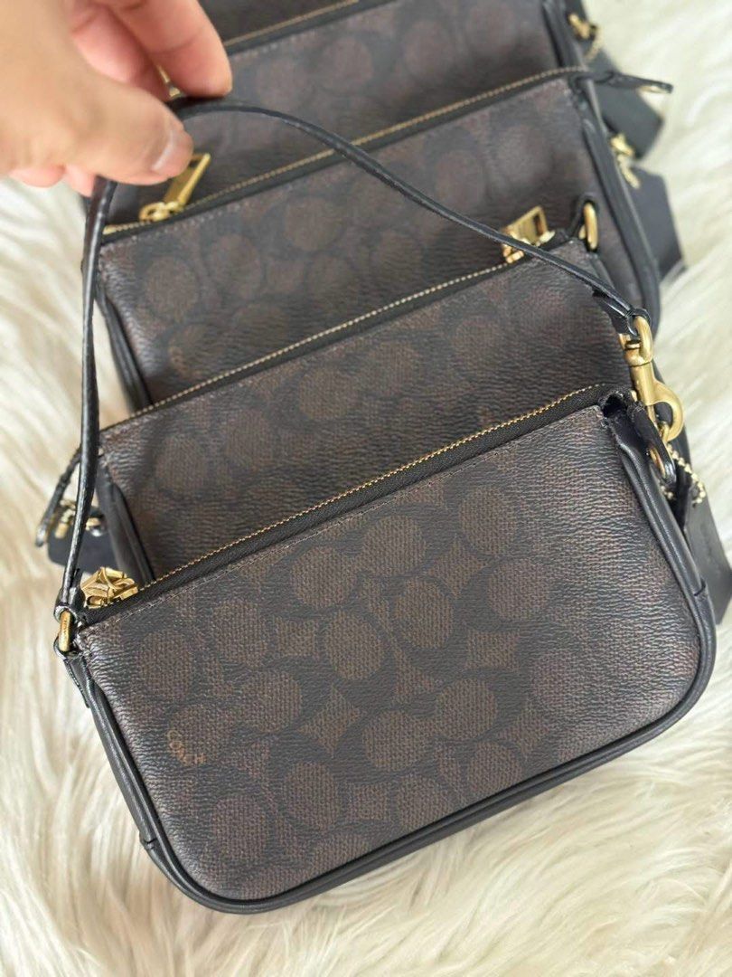 Coach Signature Monogram Pouch Wristlet (Category: Luxury Bags & Wallets) located in Manila. Submitted by clairetot (Listing ID 1462370138, Image 2). Description: Original Coach monogram pouch. Classic brown and black signature print. Gold hardware and zipper. Detachable wrist strap. Interior has some cards and tags. Great for essentials. Fits easily in a larger bag..
