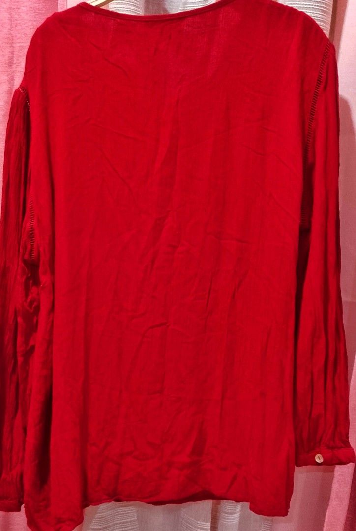 Cortefiel red cherry top XL (Category: Blouses) located in Cabanatuan. Submitted by miss.maia (Listing ID 1462406851, Image 3). Description: The Cortefiel top shown in the image is a long-sleeved, deep red bohemian-style peasant blouse. It features a fractional front button placket with a self-tie tassel or drawstring closure at the neckline, vertical pleated/pintuck shoulder details, and a loose, flowing silhouette..
