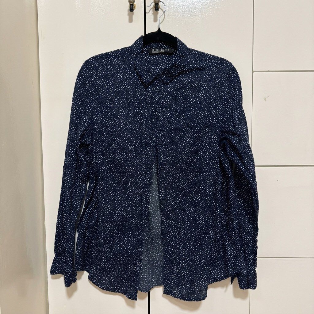 Cotton On Navy Blue Dotted Long Sleeve Shirt Size M (Category: Longsleeves) located in Angeles City. Submitted by momandmini9 (Listing ID 1462368607, Image 2). Description: - Navy blue long sleeve shirt - White dotted pattern - Button-up front - Collar neckline - Cuffs on sleeves - Relaxed fit - Versatile for casual or dressed-up occasions - Size: Medium.