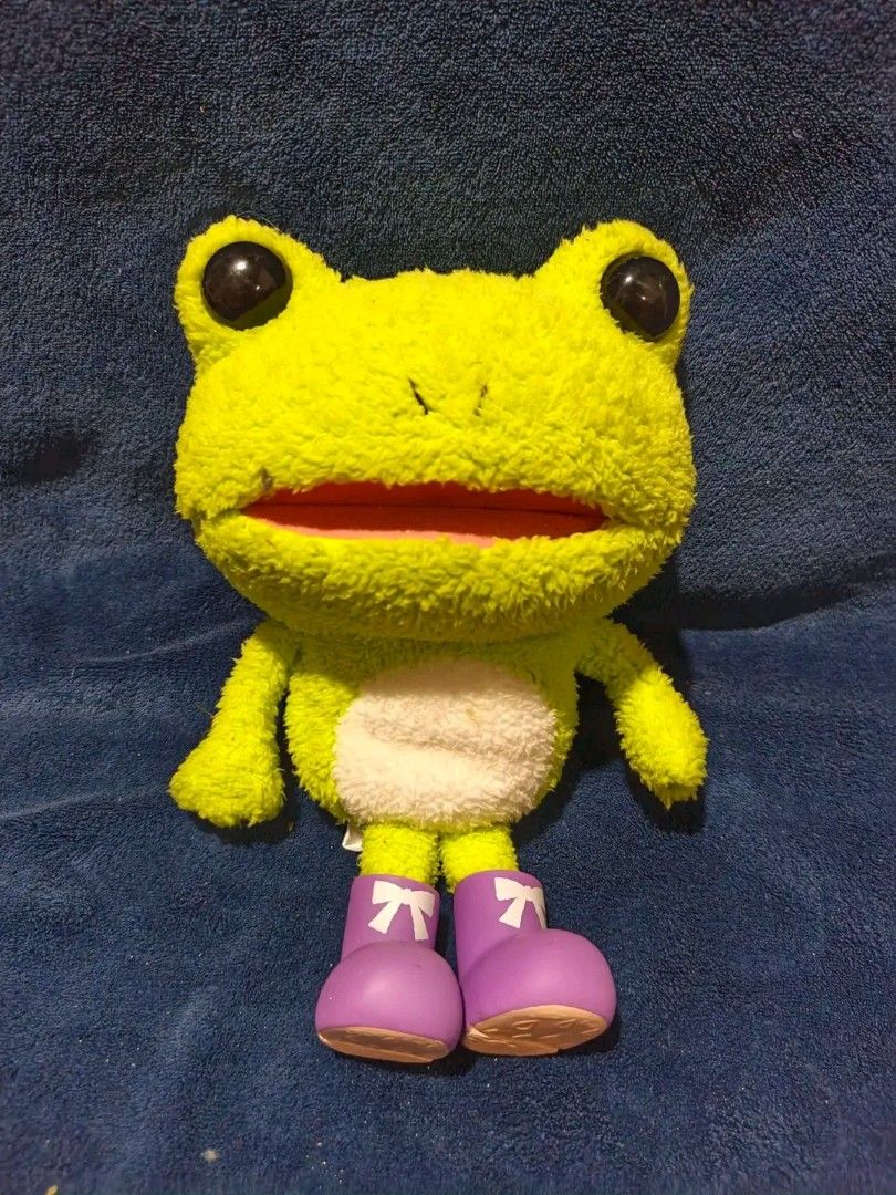 Cute Green Frog Plush Toy with Purple Boots (Category: Plushies & Soft Toys) located in Manila. Submitted by kirstentoyshub (Listing ID 1462379621, Image 1). Description: - Adorable bright green frog plushie - Features big eyes and a fuzzy belly - Comes with cute purple boots - Soft and huggable material - Ideal for frog lovers, kids, or collectors - Great as a fun decoration.