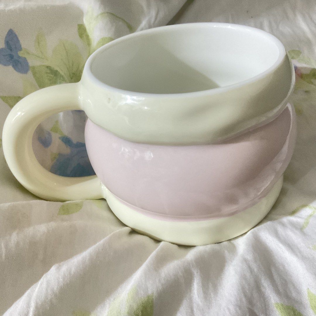 Cute Pink and Yellow Body Shaped Mug (Category: Coffee & Tea Tableware) located in Naga. Submitted by asrid.32 (Listing ID 1462362777, Image 2). Description: - Unique, quirky mug with a fun body shape. - Adorable pastel pink and yellow color scheme. - Pale yellow handle and clean white interior. - Ideal for your daily coffee or tea ritual. - A delightful and colorful addition to your kitchenware collection..