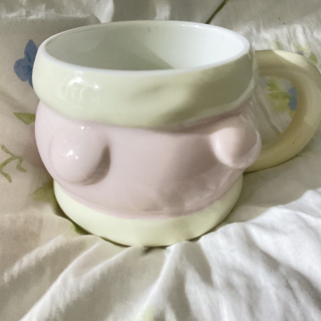 Cute Pink and Yellow Body Shaped Mug (Category: Coffee & Tea Tableware) located in Naga. Submitted by asrid.32 (Listing ID 1462362777, Image 1). Description: - Unique, quirky mug with a fun body shape. - Adorable pastel pink and yellow color scheme. - Pale yellow handle and clean white interior. - Ideal for your daily coffee or tea ritual. - A delightful and colorful addition to your kitchenware collection..