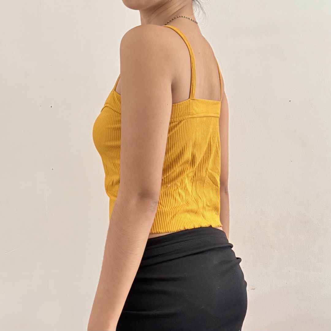 cute y2k yellow ribbed button-up crop tank top (Category: Sleeveless) located in Marikina City. Submitted by triciarchive (Listing ID 1462337207, Image 3). Description: ✨ selling more aesthetic clothes & other stuff in my profile! <3 💰 price is negotiable - fits xs to s - super comfy! rfs: decluttering model reference (me): chest: 32” waist: 25” hips: 33” height: 5’2”.