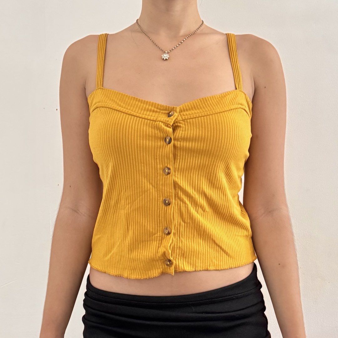 cute y2k yellow ribbed button-up crop tank top (Category: Sleeveless) located in Marikina City. Submitted by triciarchive (Listing ID 1462337207, Image 1). Description: ✨ selling more aesthetic clothes & other stuff in my profile! <3 💰 price is negotiable - fits xs to s - super comfy! rfs: decluttering model reference (me): chest: 32” waist: 25” hips: 33” height: 5’2”.