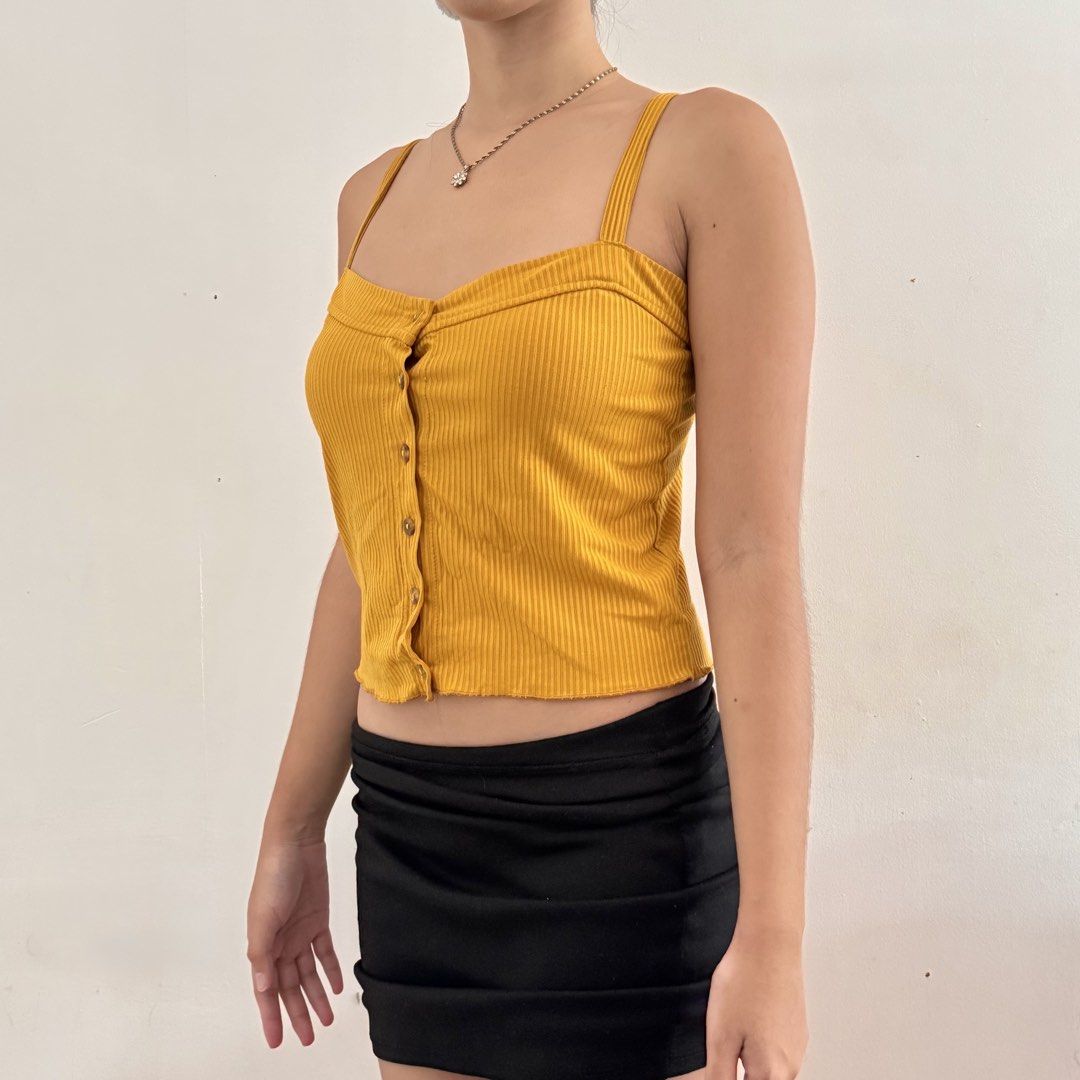 cute y2k yellow ribbed button-up crop tank top (Category: Sleeveless) located in Marikina City. Submitted by triciarchive (Listing ID 1462337207, Image 2). Description: ✨ selling more aesthetic clothes & other stuff in my profile! <3 💰 price is negotiable - fits xs to s - super comfy! rfs: decluttering model reference (me): chest: 32” waist: 25” hips: 33” height: 5’2”.