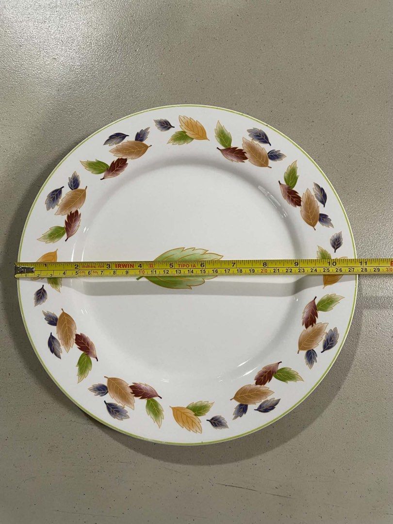Decorative Leaf Pattern Dinner Plate (Category: Dinnerware & Cutlery) located in Quezon City. Submitted by meggoquingco (Listing ID 1462346573, Image 3). Description: - White dinner plate with decorative autumn leaf motif. - Features a single large leaf centered on the plate. - Light green trim along the rim. - Approximately 11 inches in diameter. - Ideal for serving meals or as a decorative piece..