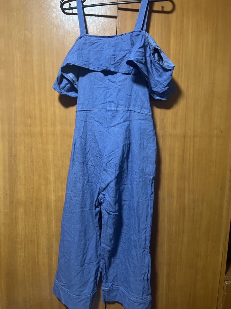 Denim Ruffle Cold Shoulder Jumpsuit (Category: Jumpsuits) located in Pasig City. Submitted by zebteashoppe01 (Listing ID 1462403957, Image 2). Description: - Blue denim jumpsuit - Ruffle detail across shoulders - Short sleeves - Tie waist for a flattering fit - Button-up front - Cropped wide leg silhouette - Functional pockets - Ideal for casual outings Small to medium 09096535540 Jnt Pasig .