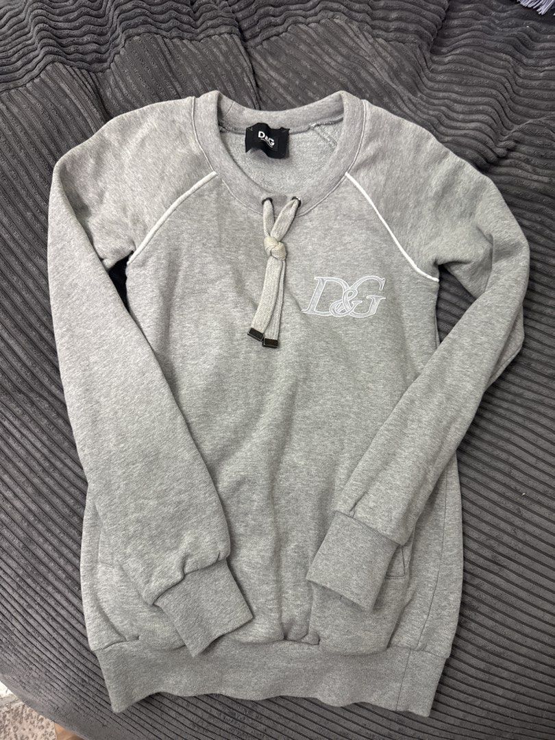 D&G Grey Sweatshirt (Category: Family Planning) located in Angeles City. Submitted by migs_font29 (Listing ID 1462390275, Image 1). Description: - Grey D&G sweatshirt - Embroidered D&G logo on front - Drawstring detail at neckline - Raglan sleeves with white piping - 100% Cotton.