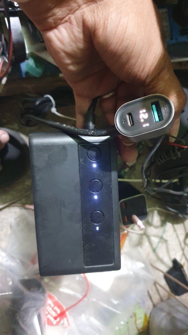 Digital Display Car Charger (Category: Batteries & Power Banks) located in Cebu City. Submitted by gelmarbrig15075 (Listing ID 1462435226, Image 1). Description: - Sleek black power bank - 4 LED indicator lights for charge status - Includes car charger adapter with digital voltage display - Dual charging ports: USB and USB-C - Perfect for charging devices anywhere, anytime.
