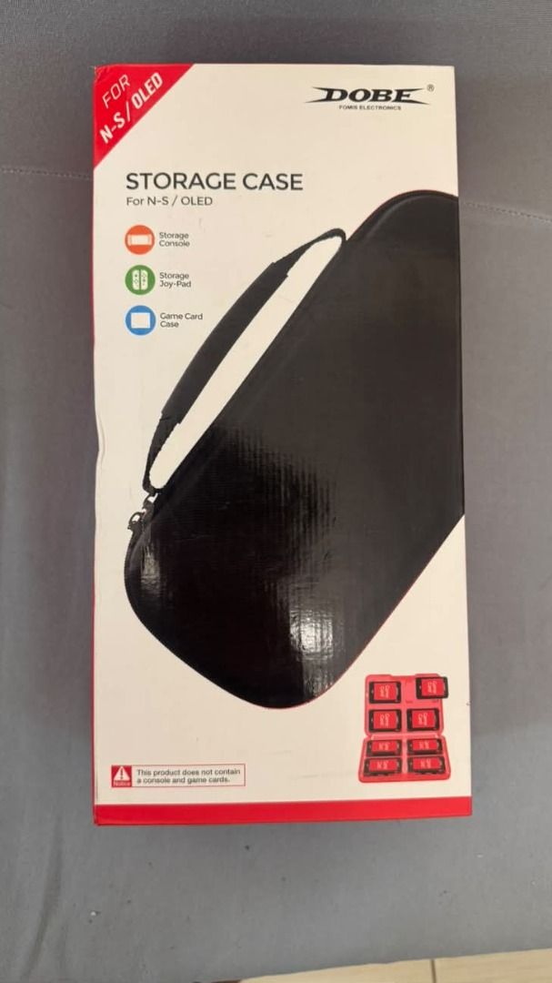 DOBE Storage Case for Nintendo Switch N-S/OLED (Category: Cases & Covers) located in Taguig. Submitted by aaron.d28 (Listing ID 1462426853, Image 1). Description: - DOBE Black Storage Case for Nintendo Switch & Switch OLED - Holds console, toy pad, and game cards - Features a convenient handle for easy carrying - Protects your Nintendo Switch and accessories - Keeps everything organized and tidy - Ideal for travel or home storage.
