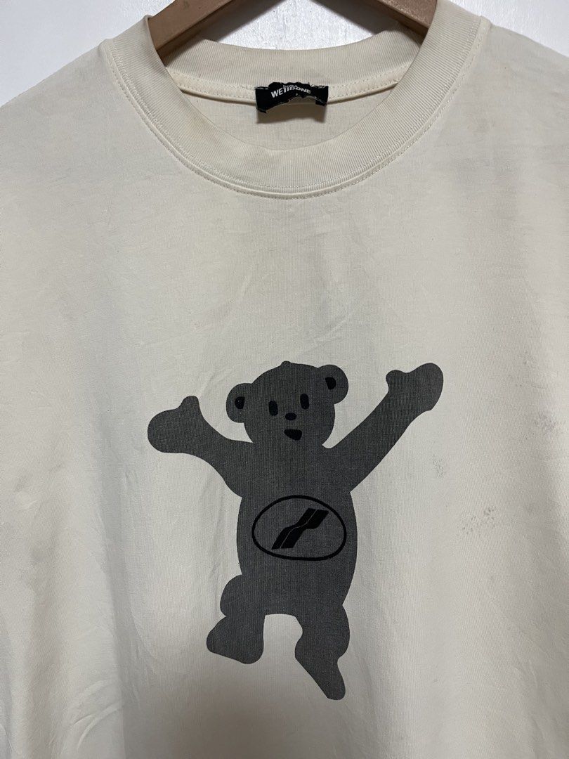DORA WET1DONE Bear Graphic T-Shirt (Category: Shirts) located in Tanza. Submitted by feliciano4108 (Listing ID 1462300262, Image 3). Description: - Cream colored t-shirt - Features a grey bear graphic on both front and back - DORA WET1DONE branding.