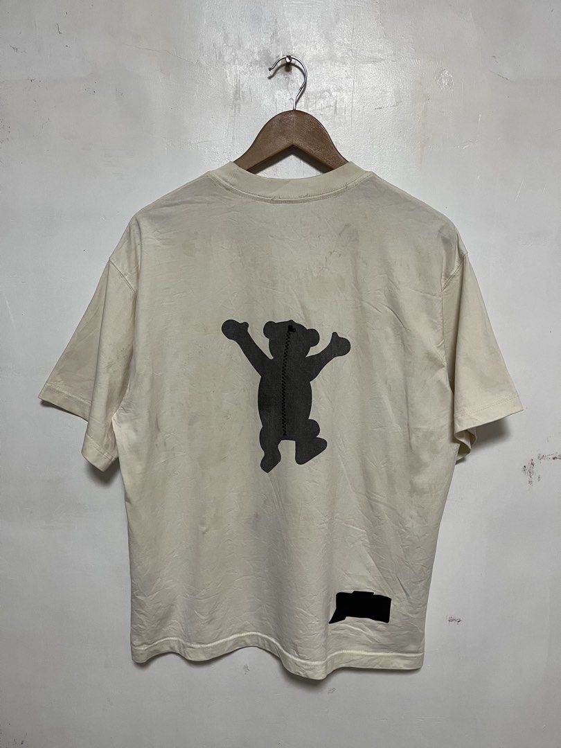 DORA WET1DONE Bear Graphic T-Shirt (Category: Shirts) located in Tanza. Submitted by feliciano4108 (Listing ID 1462300262, Image 2). Description: - Cream colored t-shirt - Features a grey bear graphic on both front and back - DORA WET1DONE branding.