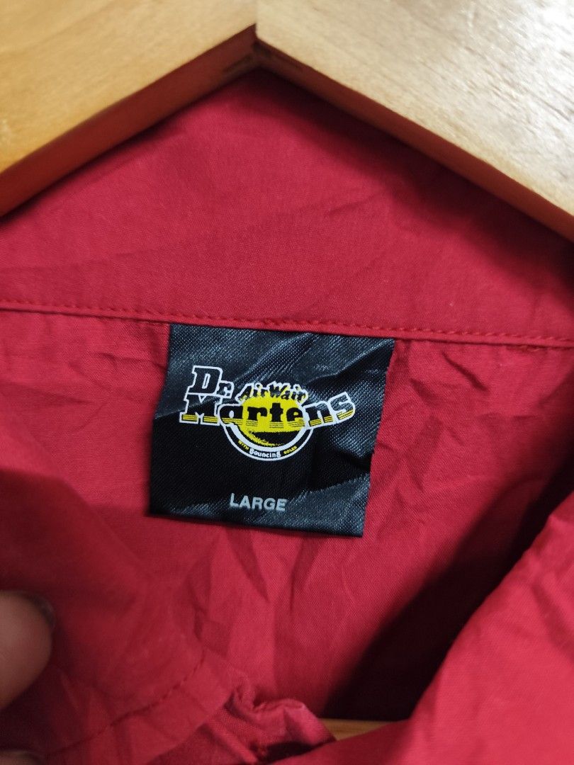 Dr Martens Airwair Buttons Down Polo (Category: Activewear) located in Compostela. Submitted by fashiondeamar (Listing ID 1462367044, Image 3). Description: ​Item Overview ​Brand: Dr. Martens (AirWair) ​Item Type: Short-Sleeve Button-Up Shirt / Bowling Shirt / Casual Work Shirt ​Color: Red (with white piping details on the sleeves and chest pocket) ​Size: Large (L) ​Product Code / Style Tag: DMP-5 (as seen on the inner care tag) ​Design Details ​