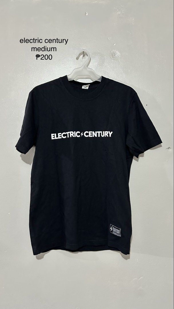 Electric Century Black T-shirt Medium (Category: Tshirts & Polo Shirts ) located in Manila. Submitted by vhhhhhhh (Listing ID 1462407810, Image 1). Description: - Black Electric Century T-shirt - Size: Medium - Graphic print on the front - Small tag detail on the bottom right - Ideal for casual wear.