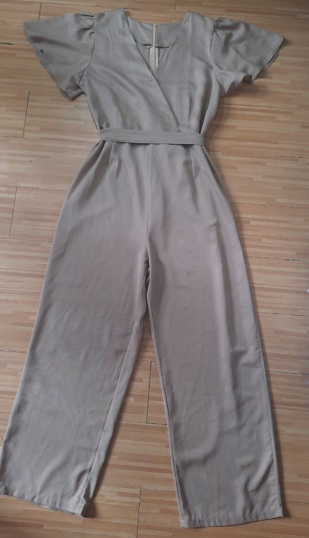 Elegant Khaki Jumpsuit (Category: Jumpsuits) located in Quezon City. Submitted by dannikkishoppe2 (Listing ID 1462387486, Image 2). Description: Elegant Khaki Jumpsuit ❗️₱400❗️ - Flattering flutter sleeves - Secure wrap front with adjustable tie waist - Comfortable wide leg pants - Measurements: Shoulder to ankle 55", Chest 16", Waist 14" - Sizing: Fits L to XL - Versatile for casual outings or dressing up.