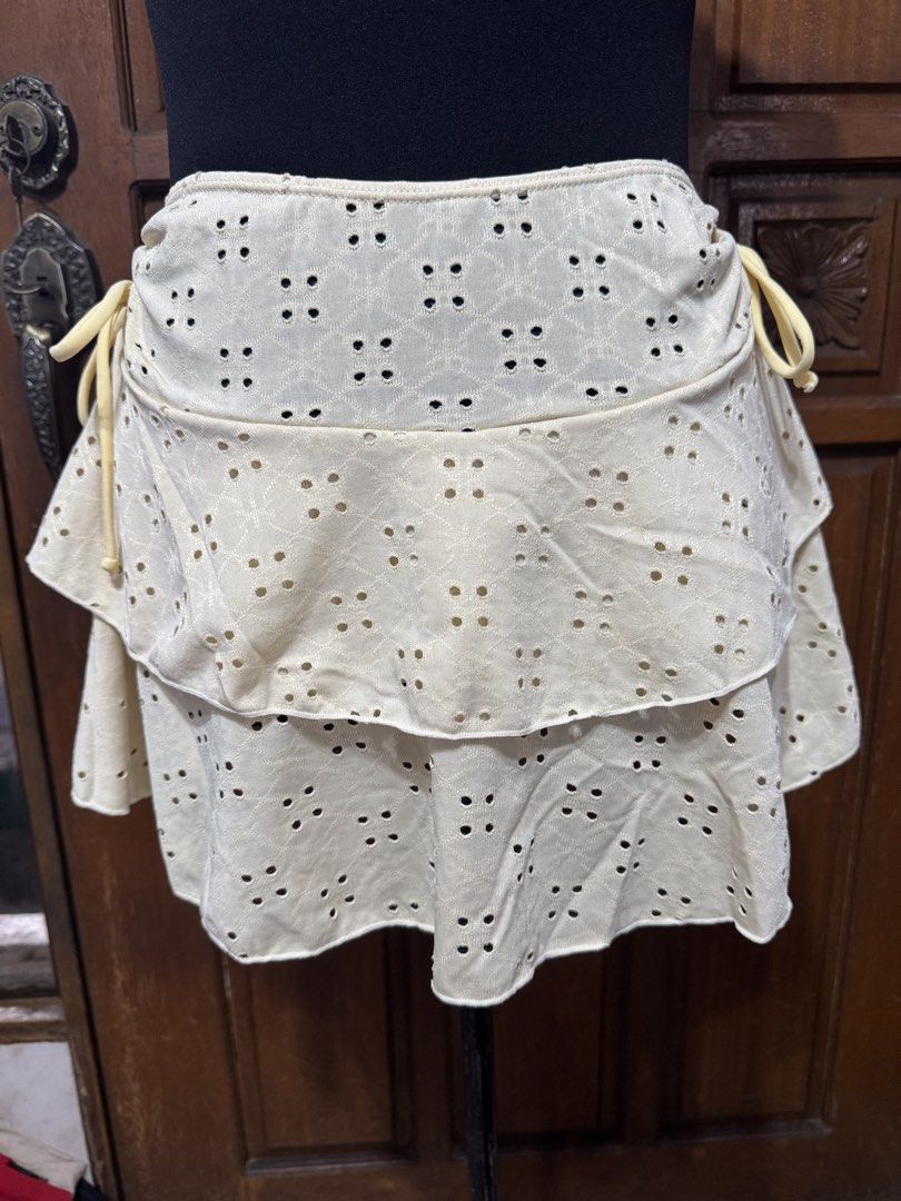 Eyelet Bikini Set with Ruffled Skirt - Size M (Category: Bikinis & Swimsuits) located in Manila. Submitted by prelovedshopmnl (Listing ID 1462275671, Image 3). Description: - Light yellow eyelet bikini set - Twisted front top - Ruffled tiered skirt - High-waisted bottoms - Material: 95% polyester, 5% elastane - Ideal for beach days and pool parties - Comfortable and stylish design.