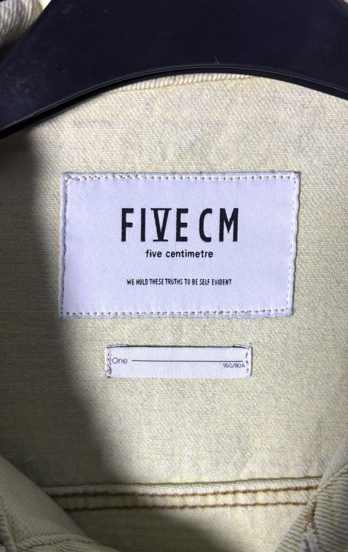 FIVE CM Two-Tone Denim Jacket (Category: Coats, Jackets and Outerwear) located in Bacoor. Submitted by calvinmanzano13 (Listing ID 1462296887, Image 3). Description: - L = 22.5” | W = 21.5” - Style: Two-tone denim trucker jacket - Colors: Light green on one side, light blue on the other - Features: Button closure, chest pockets, small neon green tag detail Notes: ☑️ Hand washed ☑️ Polished ☑️ Steam ironed.
