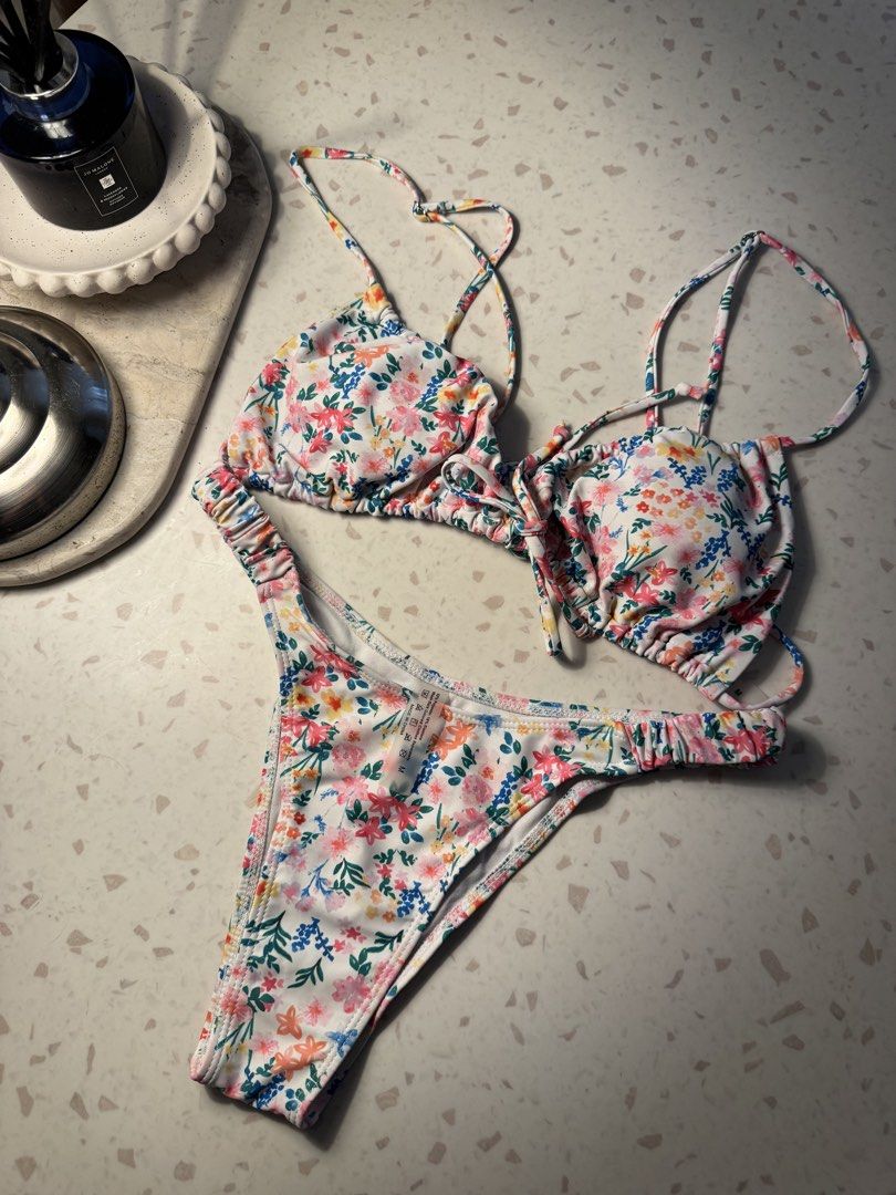 Floral Print Bikini Set (Category: Bikinis & Swimsuits) located in Las Pinas. Submitted by patringcia_14 (Listing ID 1462319239, Image 2). Description: - Adorable floral print bikini - White base with vibrant pink, yellow, blue, and green flowers - Halter neck top with adjustable tie details - Matching cheeky bottoms with elasticated waistband - Comfortable elasticated straps - Ideal for beach days and poolside lounging.