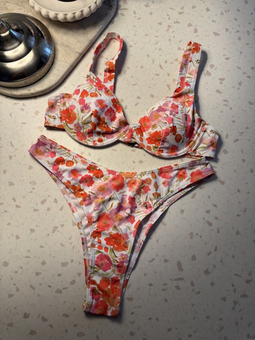 Floral Print Bikini Set - Pink, Orange, White (Category: Bikinis & Swimsuits) located in Las Pinas. Submitted by patringcia_14 (Listing ID 1462317258, Image 1). Description: - Adorable floral print bikini set - Push-up style top with adjustable straps - Matching high-cut bottoms - Vibrant colors and fun pattern - Ideal for beach days and pool parties.