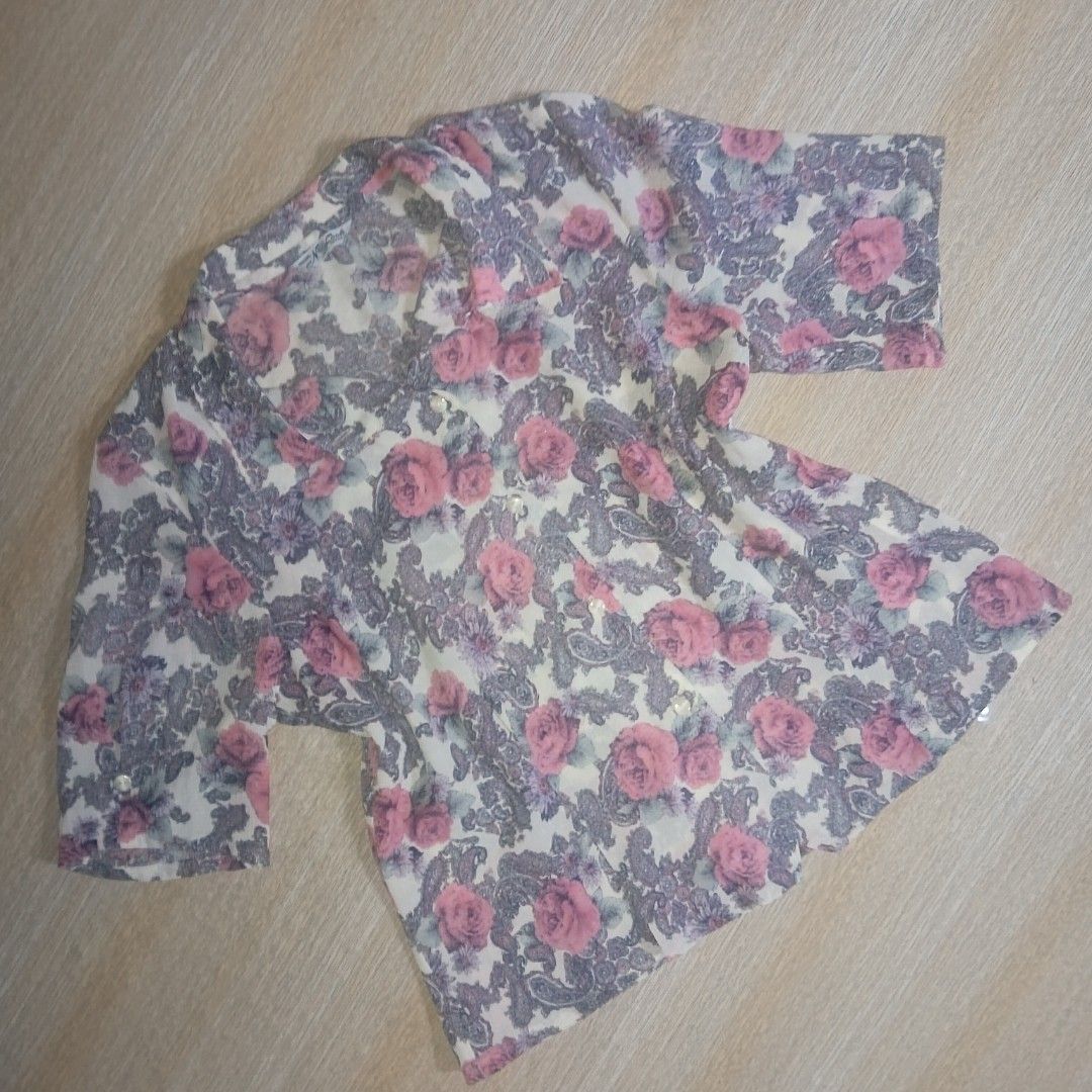 Floral Print Button-Up Blouse (Category: Blouses) located in Manila. Submitted by silentstone.4b0628 (Listing ID 1462396138, Image 2). Description: - White blouse with a charming pink rose and paisley print. - Short sleeves for a comfortable fit. - Full button-down front closure. - Made from lightweight fabric, perfect for all-day wear. - Ideal for both casual outings and dressing up..
