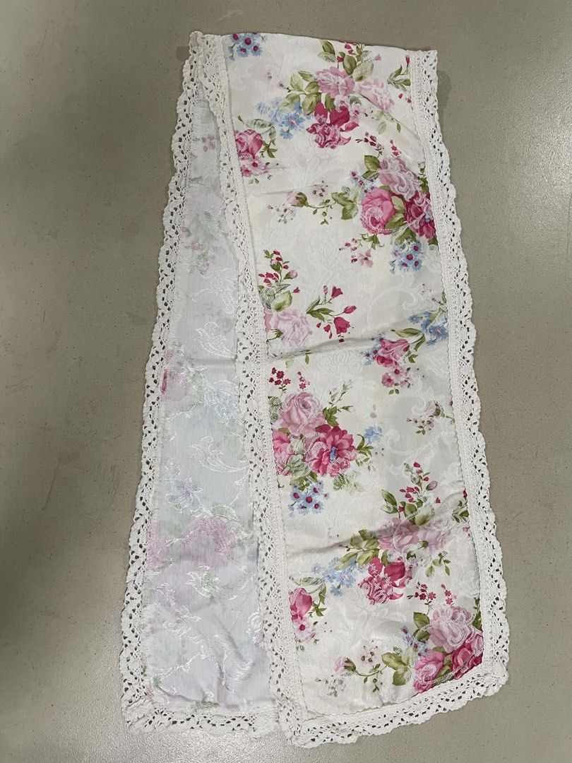 Floral Table Runner with Lace Trim (Category: Table Linen & Textiles) located in Quezon City. Submitted by meggoquingco (Listing ID 1462330248, Image 2). Description: - White table runner with a charming pink and blue floral print. - Features delicate white lace trim along the edges for an elegant touch. - Dimensions: 54 inches long and 10 inches wide. - Ideal for enhancing the decorative appeal of your dining table or sideboard..