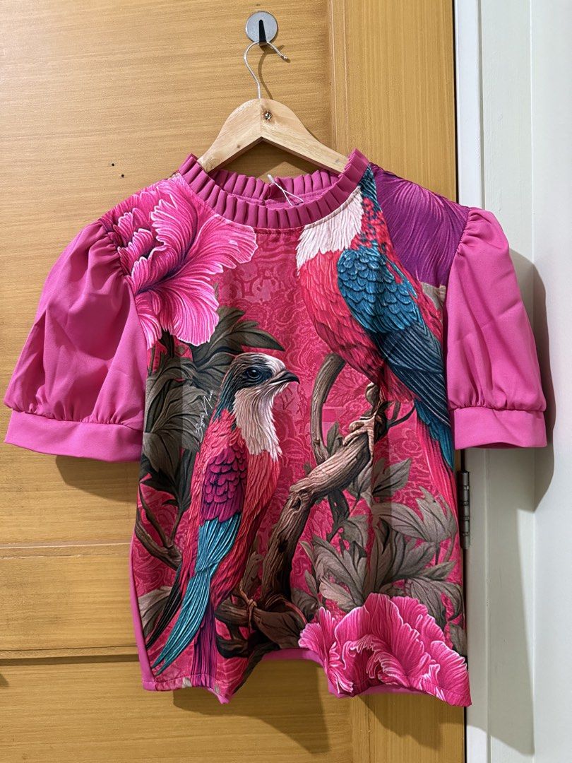 Florence 898 Bird Print Blouse (Category: Blouses) located in Taguig. Submitted by happy.viascloset (Listing ID 1461779412, Image 3). Description: - Eye-catching bright pink blouse - Beautiful bird and floral print - Features stylish puff sleeves - Elegant ruffled neckline - Unique and vibrant design - Perfect for dressing up or down - Adds a pop of color to your outfit.