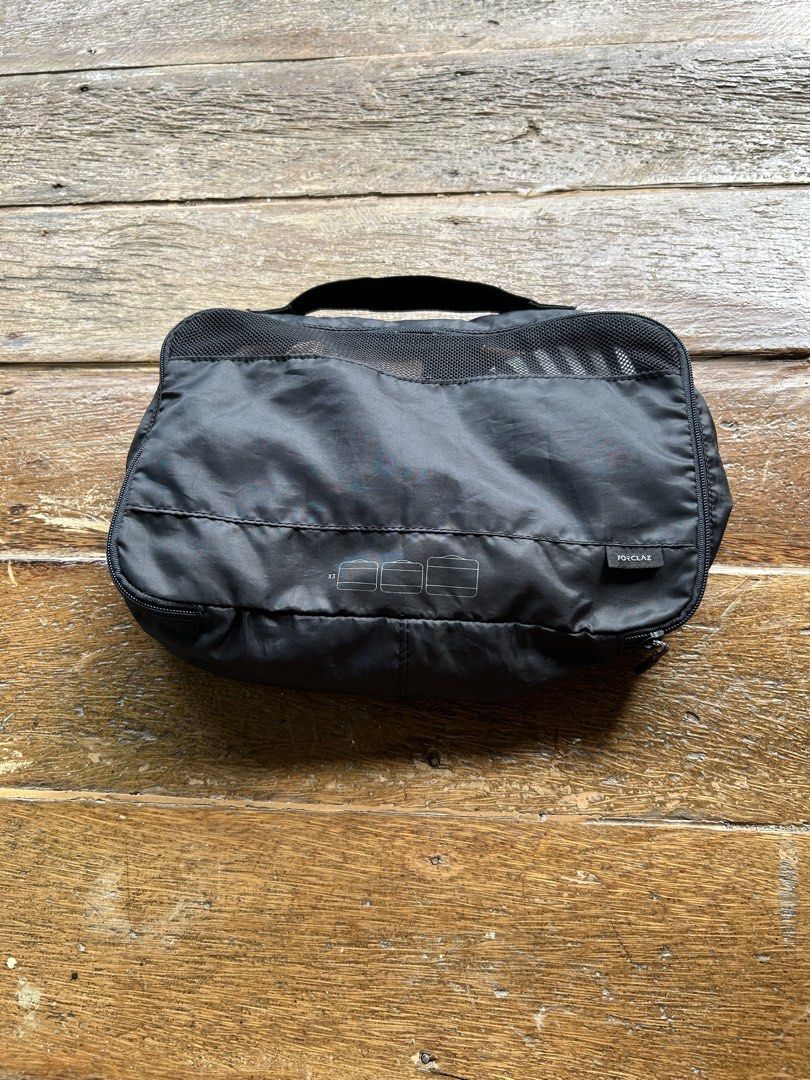 Forclaz Black Mesh Top Packing Cube Organizer (Category: Travel Essentials & Accessories) located in Surigao. Submitted by chastnavarrete (Listing ID 1462395910, Image 1). Description: - Brand: Forclaz - Color: Black - Feature: Mesh top for ventilation - Closure: Zipper - Handle: Top handle for easy carrying - Use: Ideal for organizing clothes and gear in luggage, travel, or storage - Benefit: Helps keep items tidy and accessible.