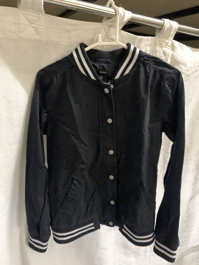 Forever 21 Black Varsity Bomber Jacket (Category: Coats, Jackets and Outerwear) located in Manila. Submitted by jo.arban (Listing ID 1462394588, Image 1). Description: - Classic black varsity bomber jacket from Forever 21 - White striped ribbed collar, cuffs, and hem - Snap button closure - Two side pockets - Ideal for casual wear and easy styling.