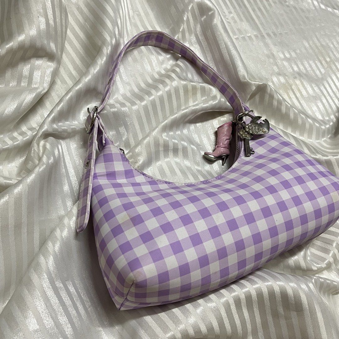 Forever 21 Gingham Y2K Shoulder Bag (Category: Shoulder Bags) located in Manila. Submitted by ave.archives (Listing ID 1462358371, Image 2). Description: Super cute and trendy Y2K-style shoulder bag from Forever 21! Featuring a lovely lilac and white checkered (gingham) pattern, grommet strap details, and comes with the adorable charms attached to the zipper pull. Perfect for adding a sweet, coquette, or vintage touch to your daily outfits. • Bra