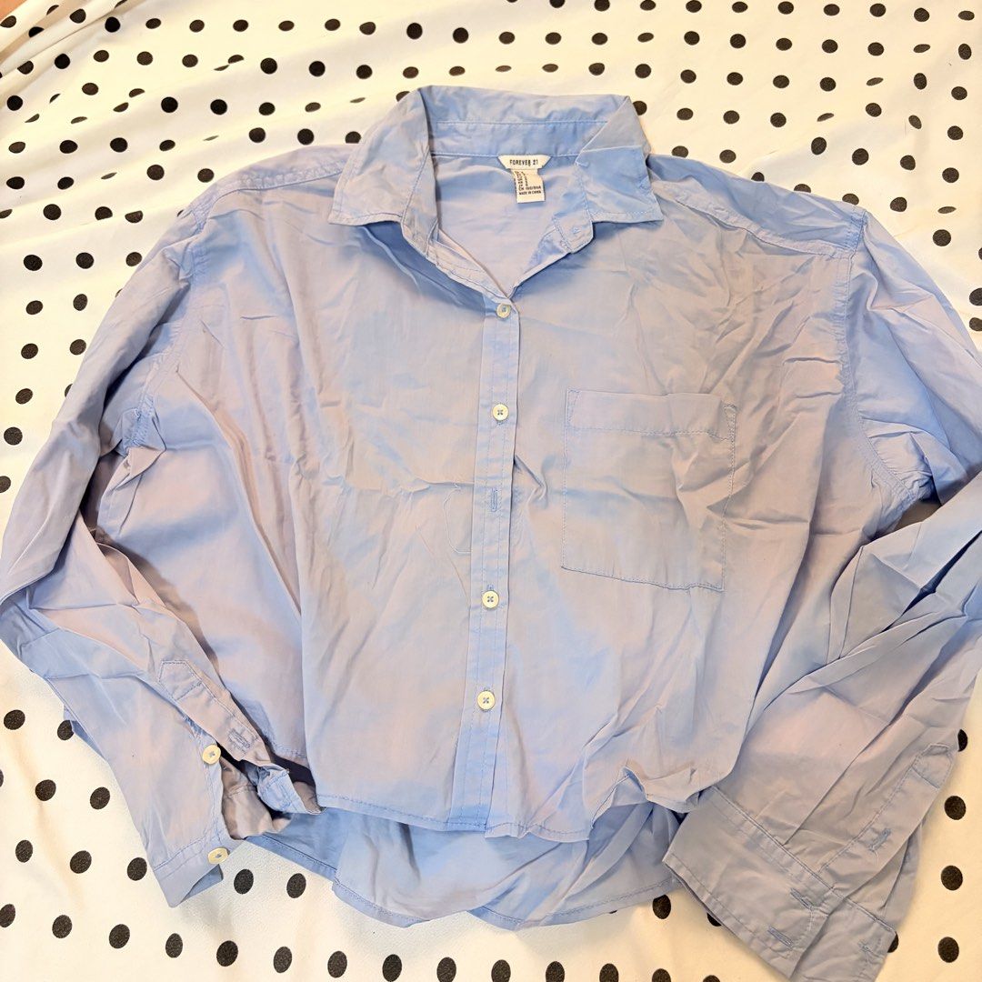 Forever 21 Light Blue Cropped Button-Up Shirt Size S (Category: Shirts) located in Pasay City. Submitted by notellyyyy (Listing ID 1462279821, Image 1). Description: - Light blue button-up shirt from Forever 21 - Cropped style - Chest pocket - Long sleeves with button cuffs - Relaxed fit - Easy to pair with jeans or shorts - Great for casual wear.