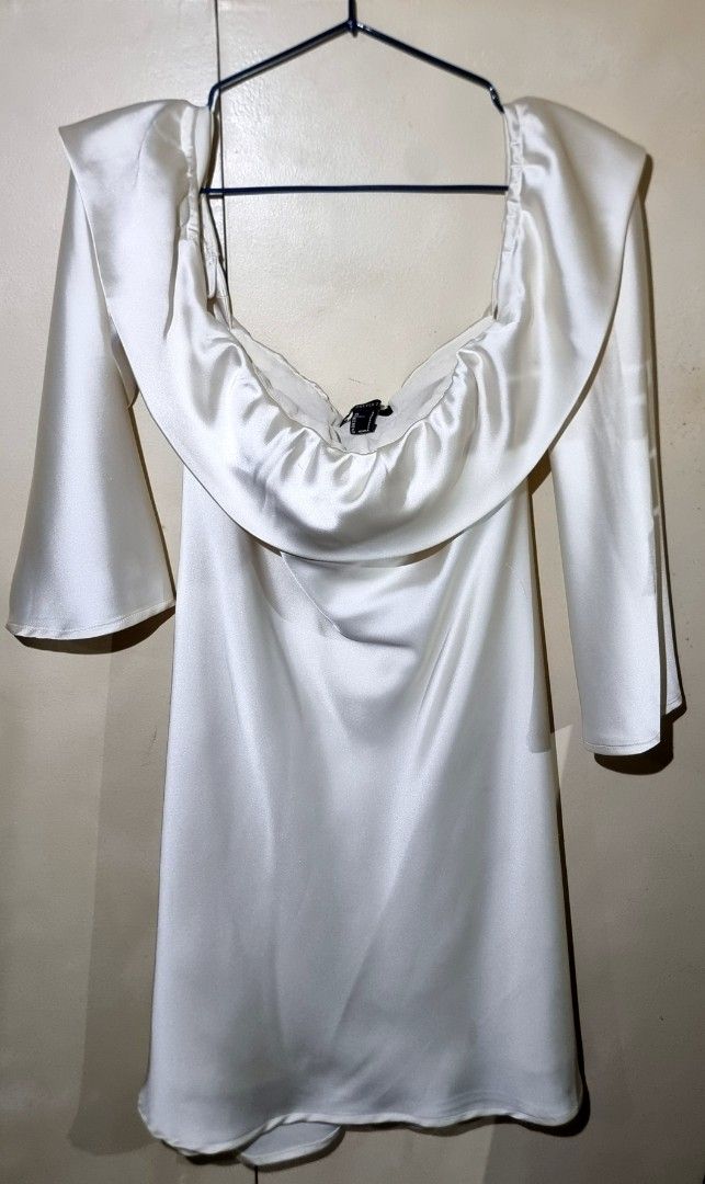 Forever 21 Off Shoulder Ruffle Satin Dress (Category: Dresses) located in Quezon City. Submitted by thriftislayp (Listing ID 1462316713, Image 2). Description: ♡ White off-the-shoulder mini dress featuring a ruffled overlay neckline and long side sleeves. ♡ Satin material ♡ Mini length ♡ Fits sizes XS to M ₱300 negotiable.