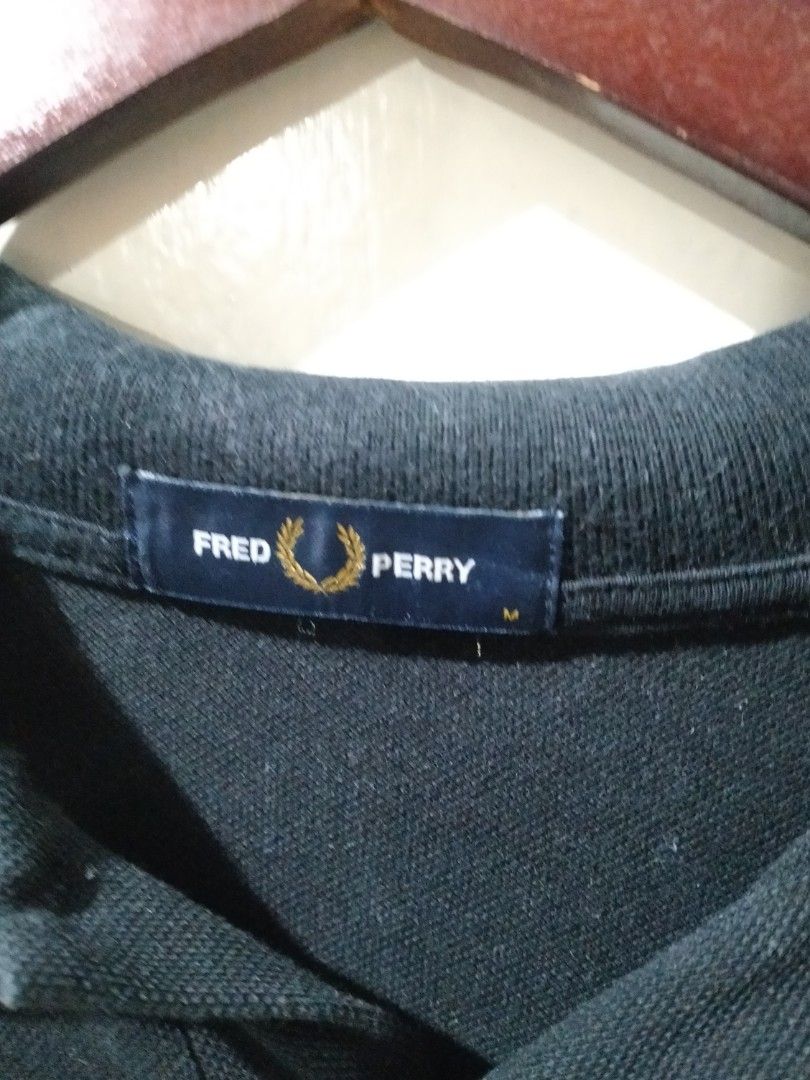 Fred Perry Polo Shirt Black Yellow Trim Size M (Category: Tshirts & Polo Shirts ) located in Quezon City. Submitted by j_tino_ishi260 (Listing ID 1462418521, Image 2). Description: - Classic Fred Perry polo shirt - Navy blue with yellow collar and sleeve trim - Iconic embroidered laurel wreath logo on chest - Size: Medium (M) - Made in China - Perfect for casual wear.